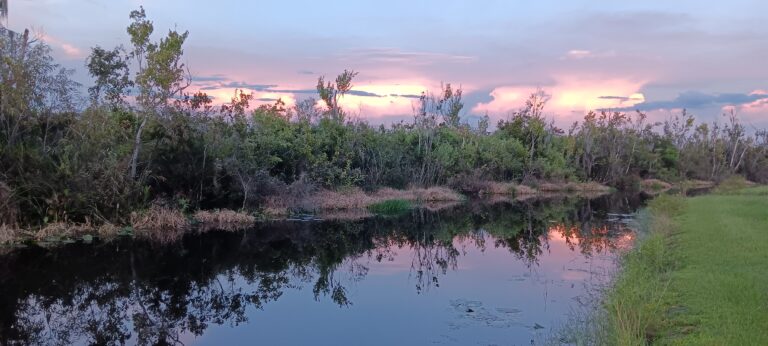 Pastel sunset clouds reflected in a still Big Pine Island waterway